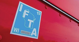 IFTA decal on side of CMV
