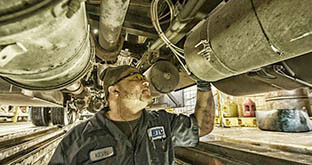 Maintenance technician inspecting vehicle