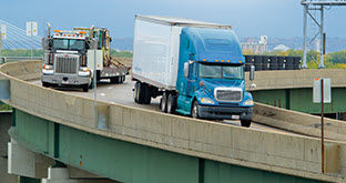 Semi trucks merging on highway