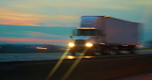 Blurry semi driving at night
