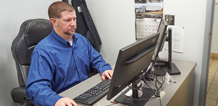 Fleet manager at computer