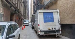 Delivery van parked in alley