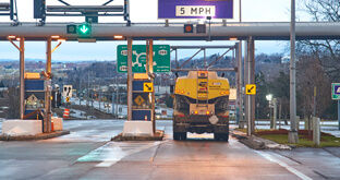Truck driving through tollbooth