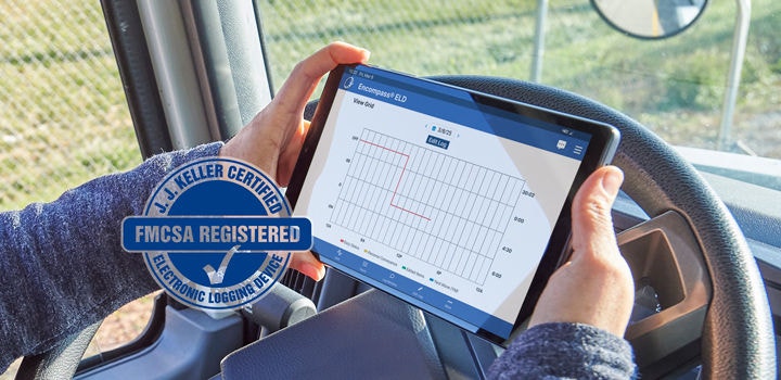 Driver holding tablet looking at tablet and FMCSA Registered stamp