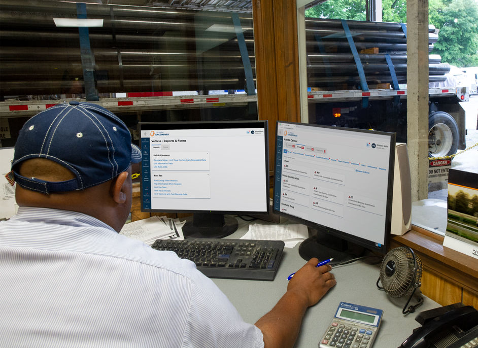 Fleet Manager in office at computer