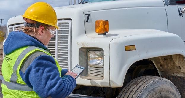 Driver inspecting truck using eDVIR app on tablet