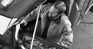 Truck driver climbing into cab