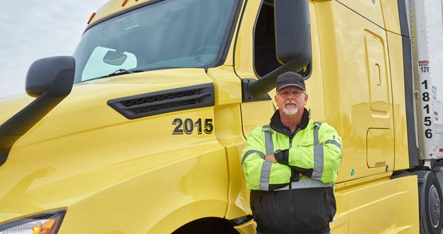Proud owner operator standing by truck