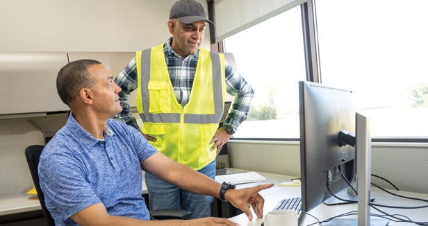 Manager and Driver talking in office