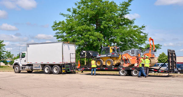 box truck with trailer hauling pavement rollers