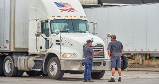 Truck driver talking to fleet manager