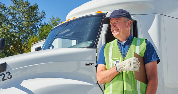 Driver standing by truck
