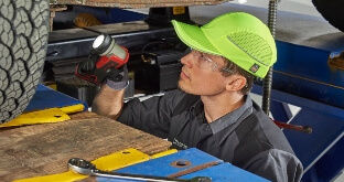 Technician inspecting truck tires