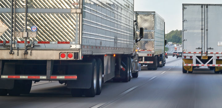 Semi trucks in highway traffic tailgating