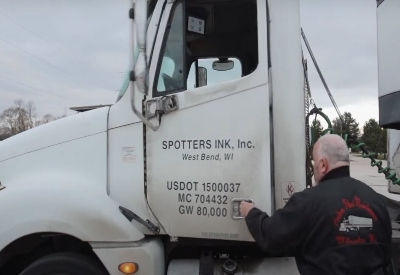 Driver getting into Spotters Ink truck