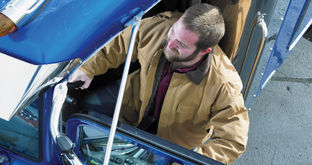 Truck driver getting into cab