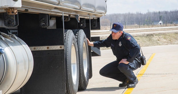 Inspector looking at trailer tires