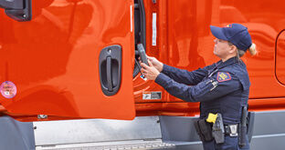 Officer conducting a roadside inspection