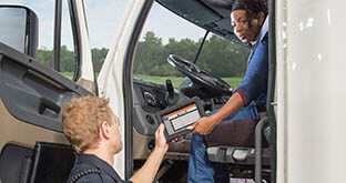 Driver handing ELD tablet to officer