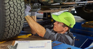Truck mechanic inspecting a vehicle
